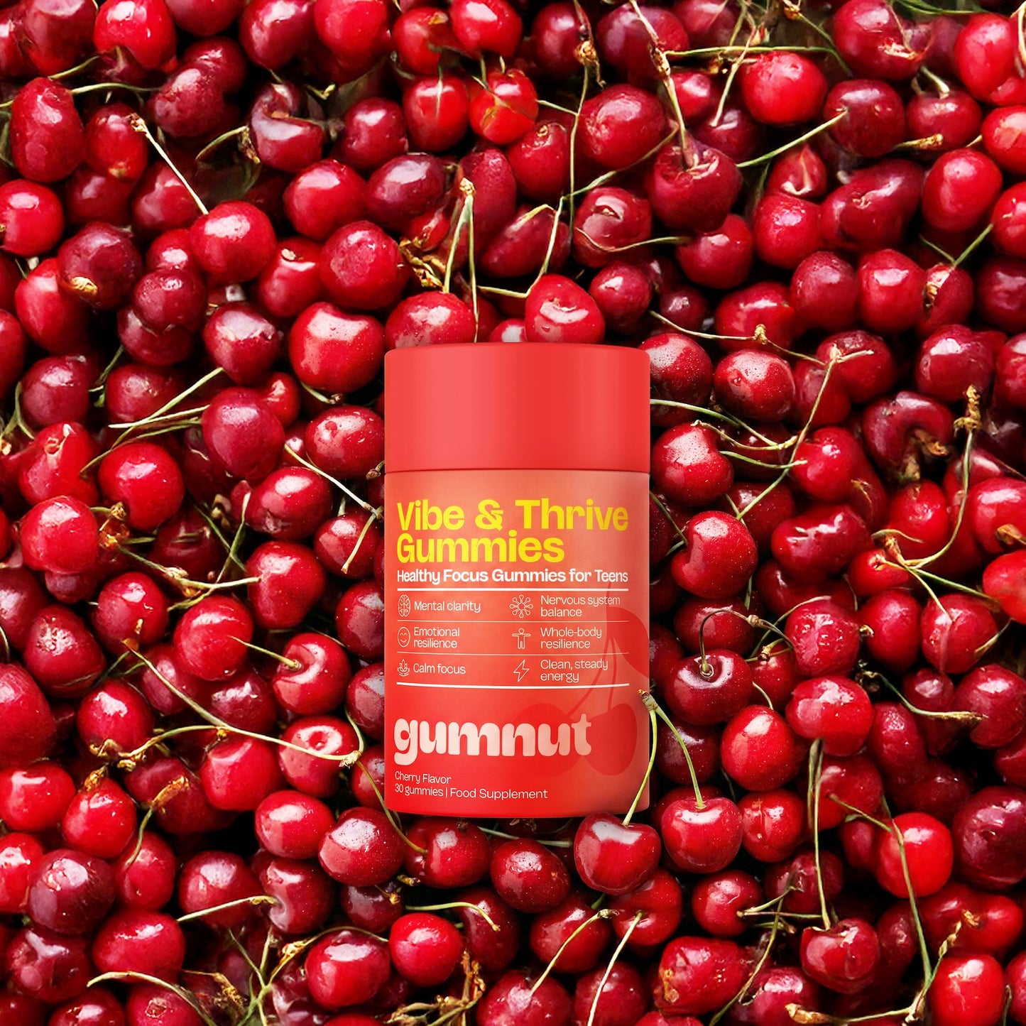 Vibe & Thrive Gummies container surrounded by red cherries